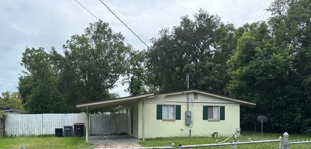 Single-story Florida home with a carport and fenced yard